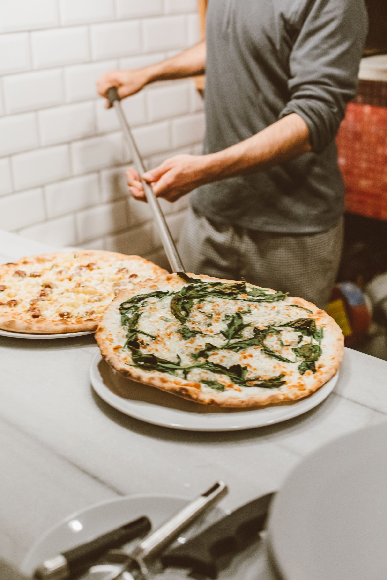 A pizza going into the oven