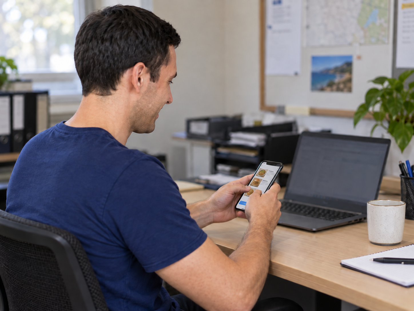 Illustrative customer ordering takeaway on his phone at work